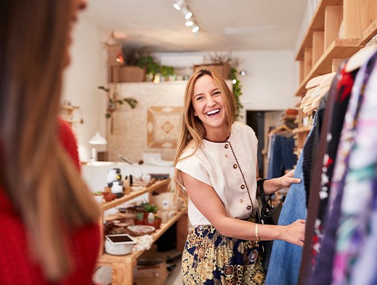 Woman smiling while shopping with friend in store