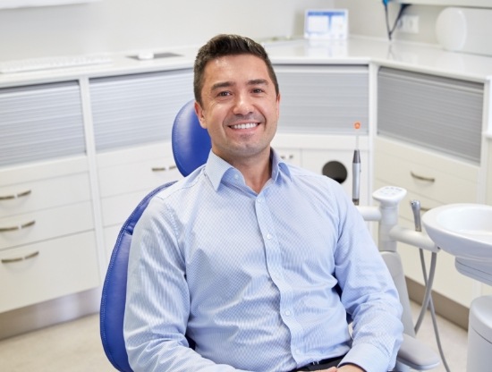 Man smiling in dental chair after getting Bioclear restoration in Rocky Hill