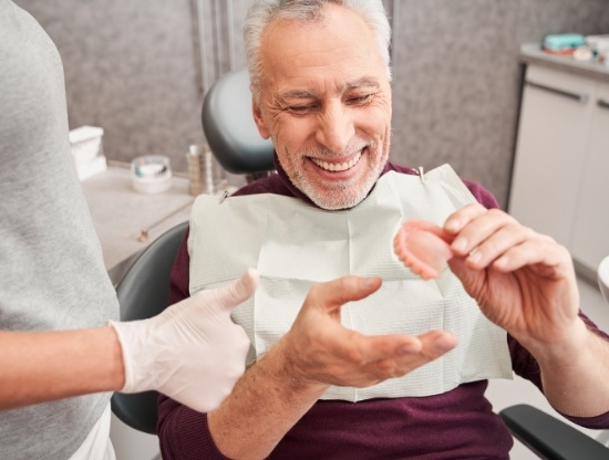 Closeup of woman wearing dentures in Rocky Hill