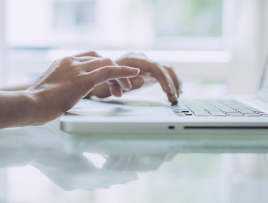 Person typing on laptop