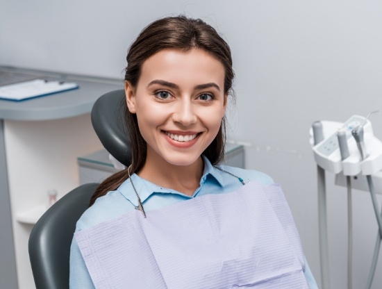 Smiling young woman in dental chair