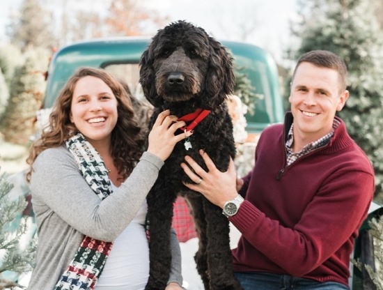 Doctor Karpman and her husband with their fluffy black dog