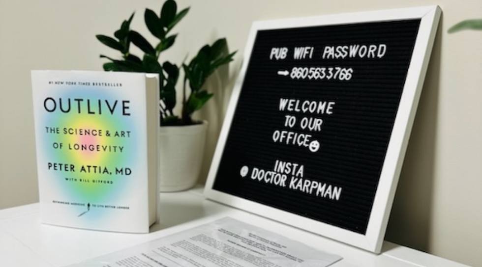 Small board on desk that says welcome to our office along with the Wi Fi password and Instagram handle