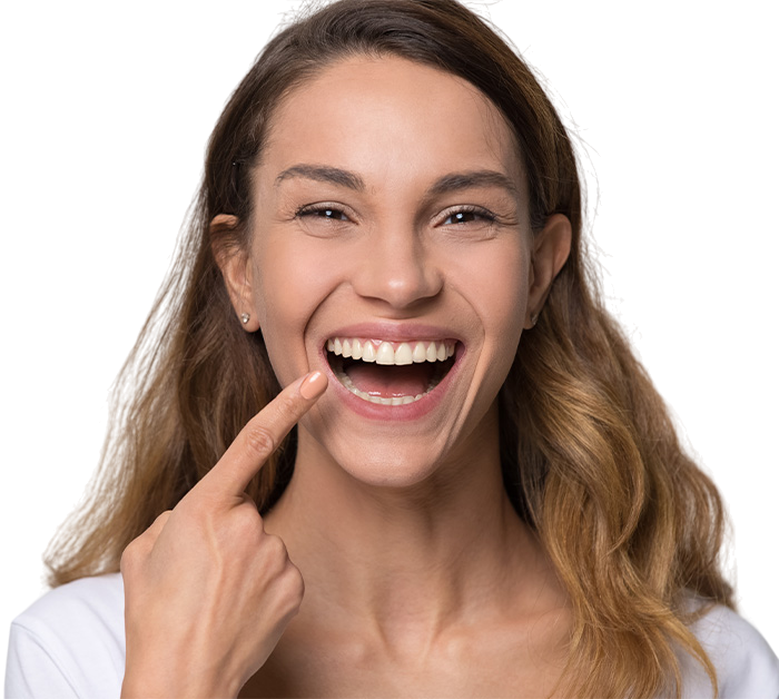Smiling woman pointing at her teeth