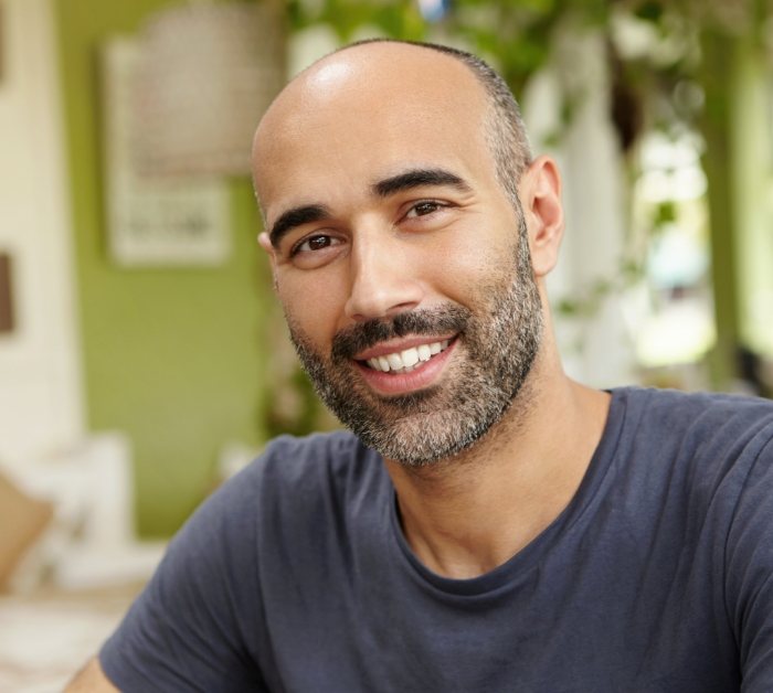 Smiling man in dark gray tee shirt