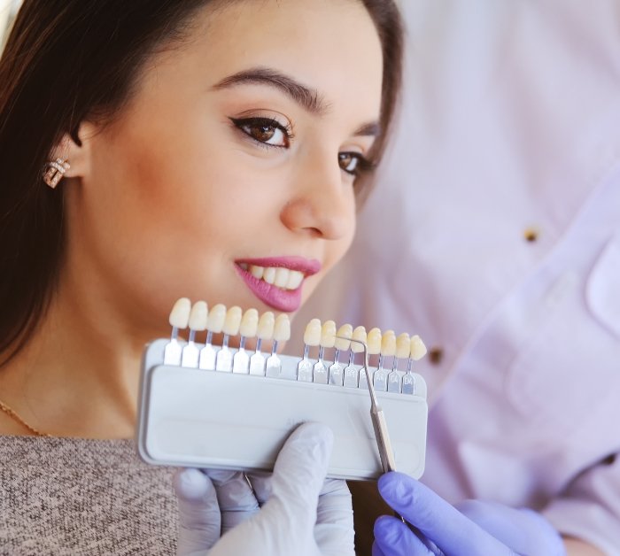 Woman smiling with veneers in Rocky Hill on blue background