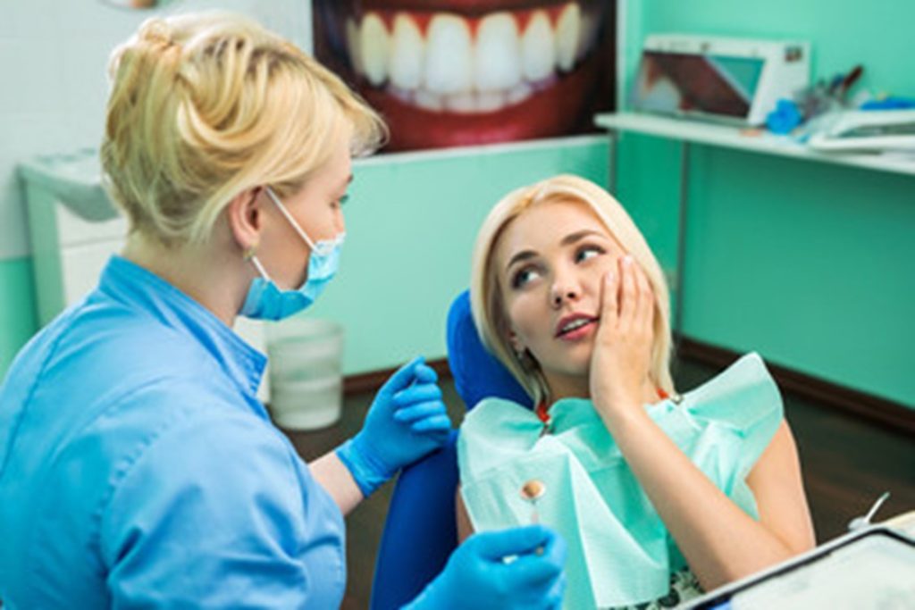 Woman at the dentist for an emergency dental visit.