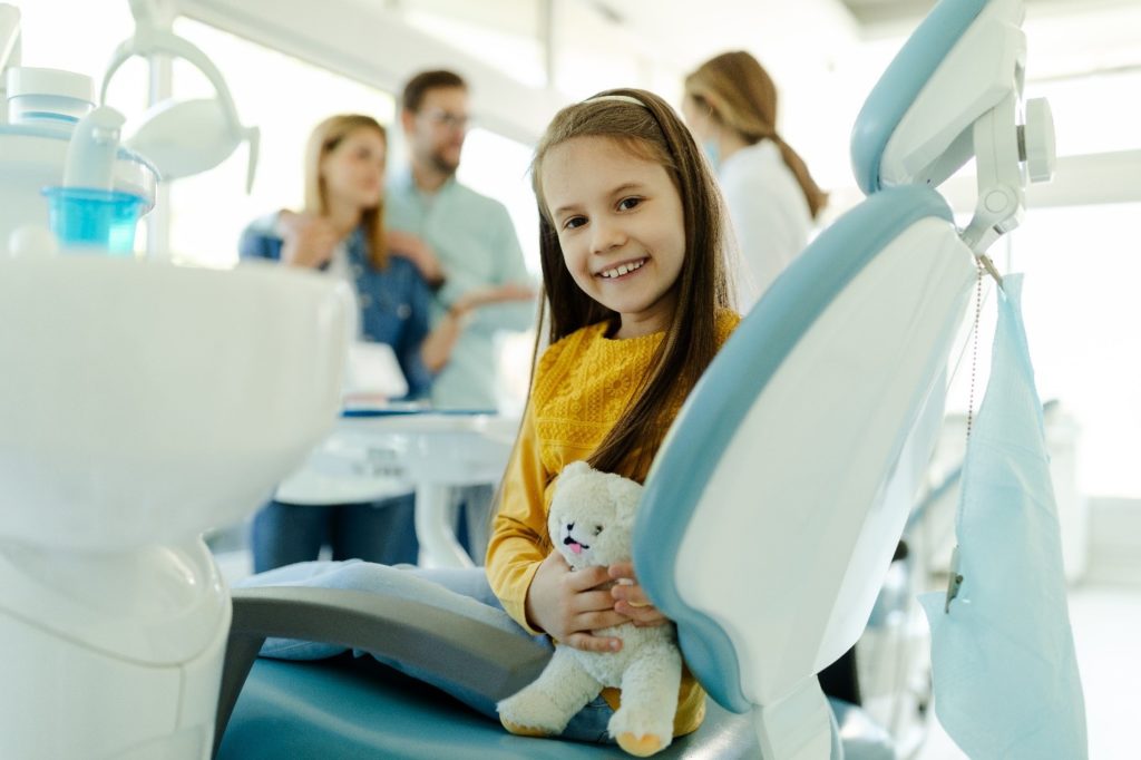 child at the dentist to get dental sealants