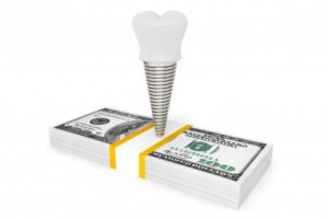 a dental implant over a stack of money