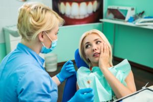 Woman with dental emergency in dentist’s chair