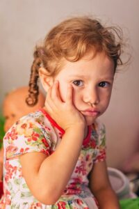 Young girl with tooth pain